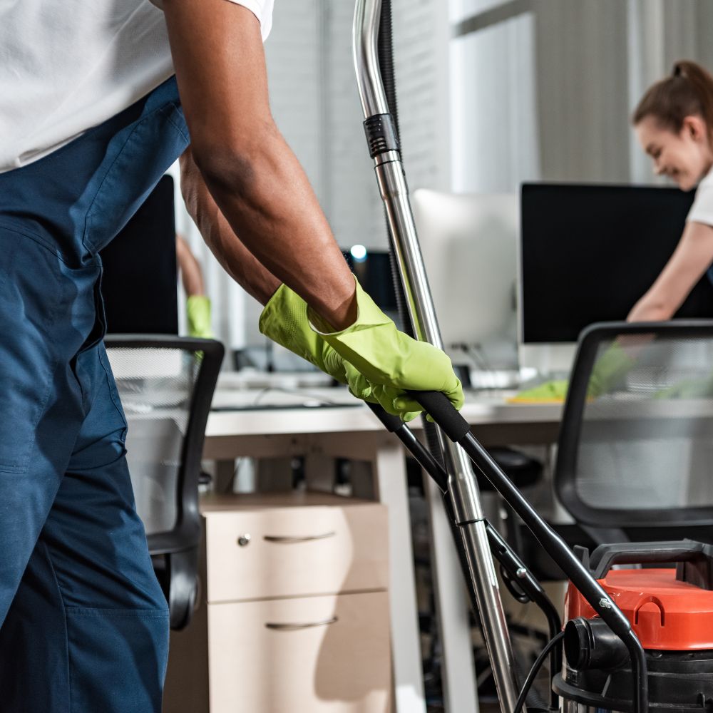 cleaning team servicing office workspace